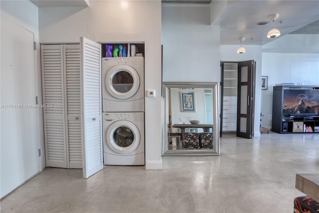 laundry room featuring laundry area, stacked washer / dryer, and visible vents