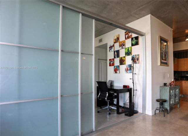 home office with concrete flooring and visible vents