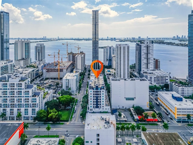 drone / aerial view featuring a water view and a view of city