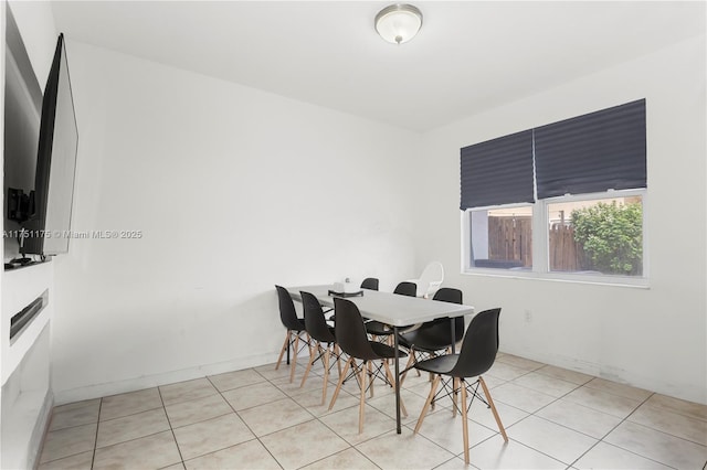 dining room featuring baseboards and light tile patterned flooring