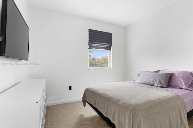 bedroom featuring carpet and baseboards