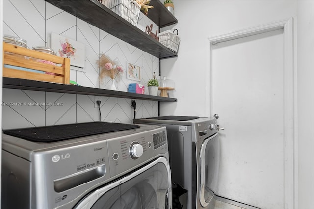 clothes washing area featuring washing machine and dryer and laundry area