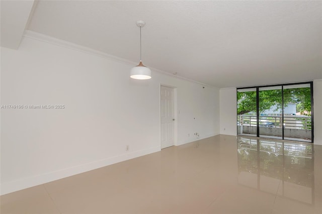 tiled spare room with a wall of windows, ornamental molding, a textured ceiling, and baseboards