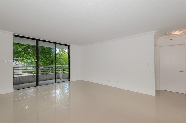 spare room with baseboards, floor to ceiling windows, a textured ceiling, and ornamental molding