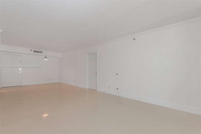 empty room with visible vents, crown molding, and a textured ceiling