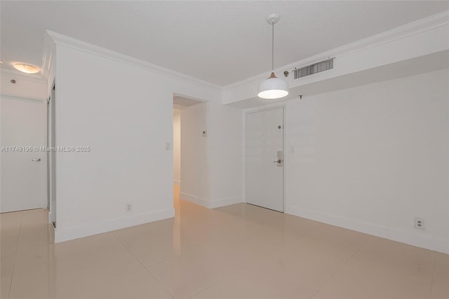 empty room with ornamental molding, visible vents, a textured ceiling, and baseboards