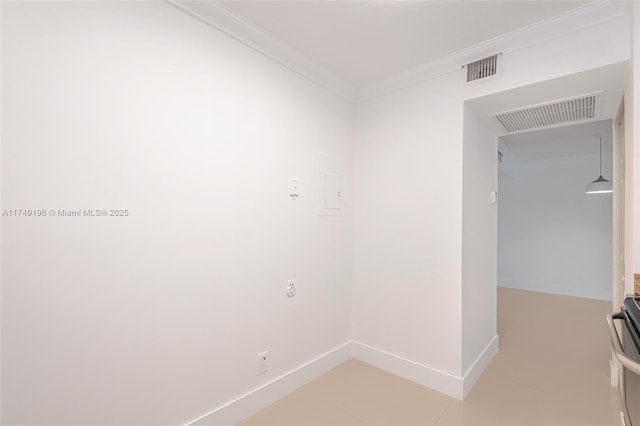 spare room featuring baseboards, visible vents, and crown molding