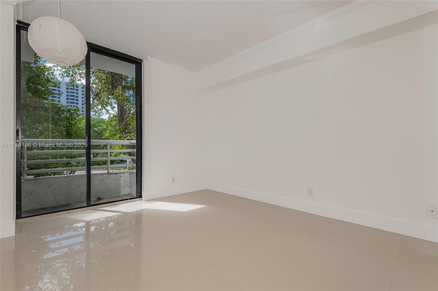 empty room featuring expansive windows, crown molding, and baseboards