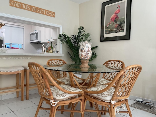 dining space featuring light tile patterned flooring