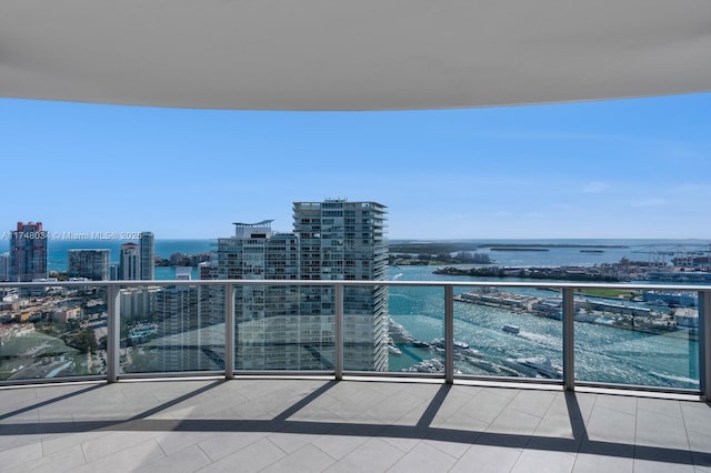 balcony featuring a view of city and a water view