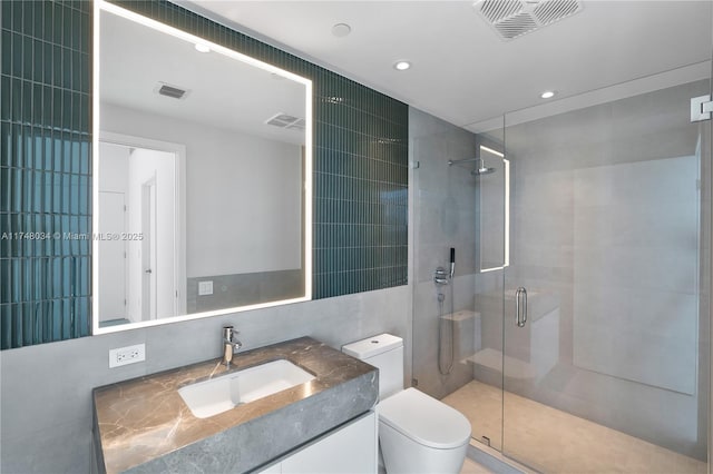 full bathroom featuring toilet, a shower stall, and visible vents