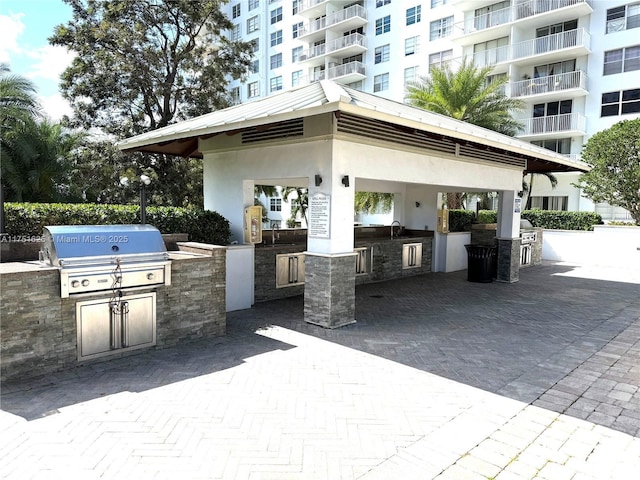 view of patio with a sink, grilling area, and exterior kitchen