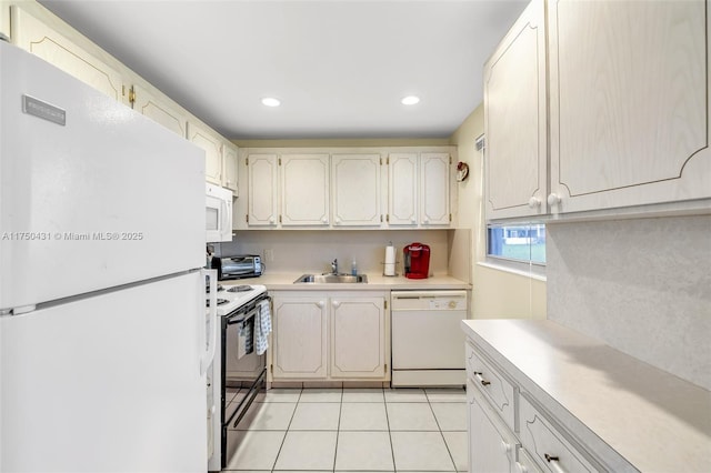 kitchen with a sink, light countertops, white appliances, recessed lighting, and light tile patterned flooring