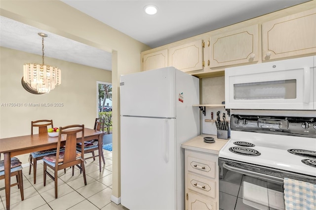 kitchen with light tile patterned floors, decorative light fixtures, an inviting chandelier, light countertops, and white appliances