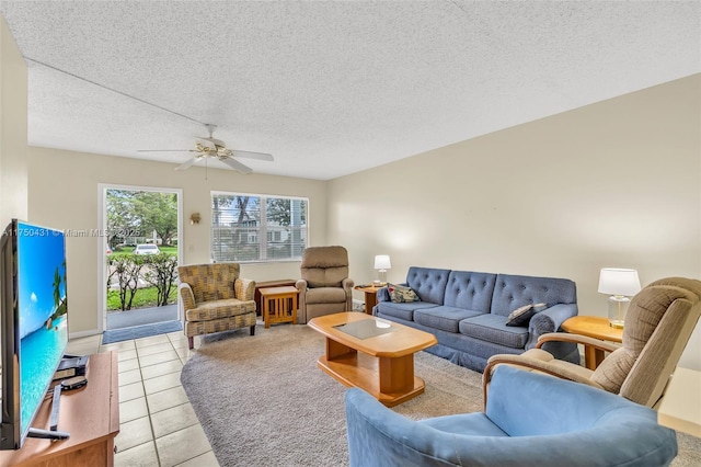 living room with light tile patterned floors, a textured ceiling, and ceiling fan