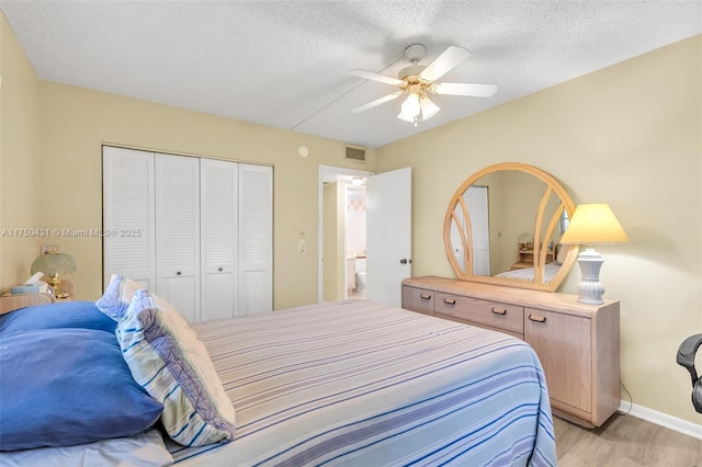 bedroom with visible vents, a closet, baseboards, a ceiling fan, and light wood-style flooring