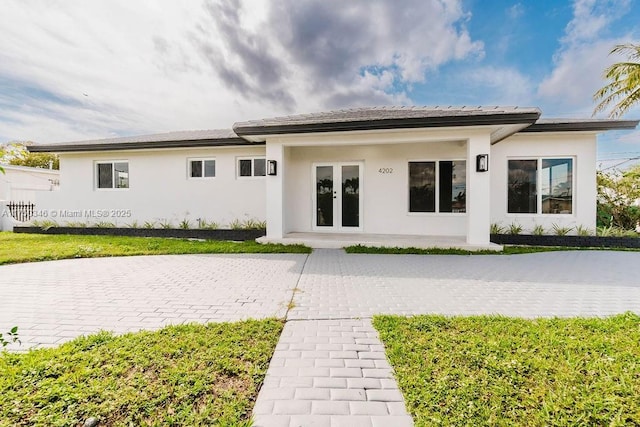 view of front of home with french doors and stucco siding