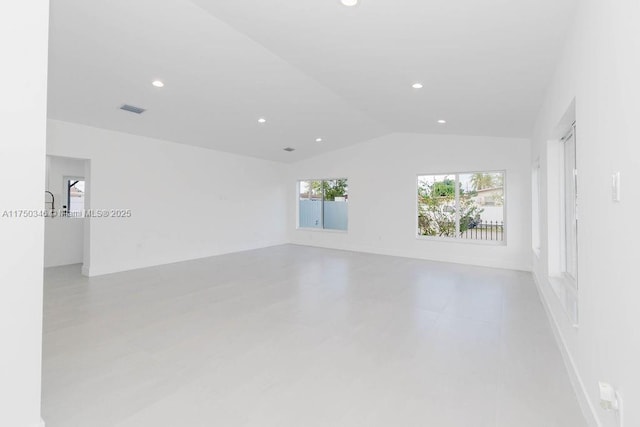 spare room with lofted ceiling, visible vents, and recessed lighting