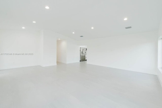 spare room featuring recessed lighting and visible vents