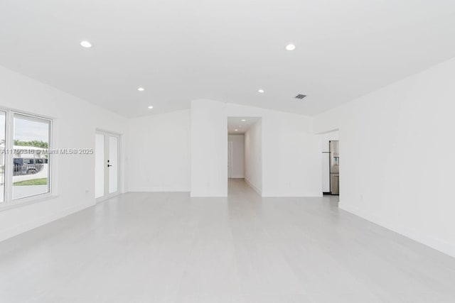empty room with recessed lighting, visible vents, and baseboards
