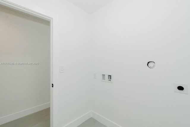clothes washing area with laundry area, baseboards, washer hookup, and hookup for an electric dryer
