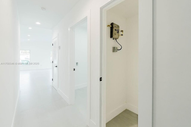 corridor featuring recessed lighting and baseboards
