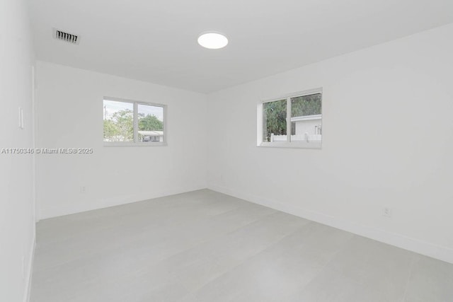 empty room with visible vents and baseboards