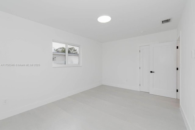 spare room featuring baseboards and visible vents