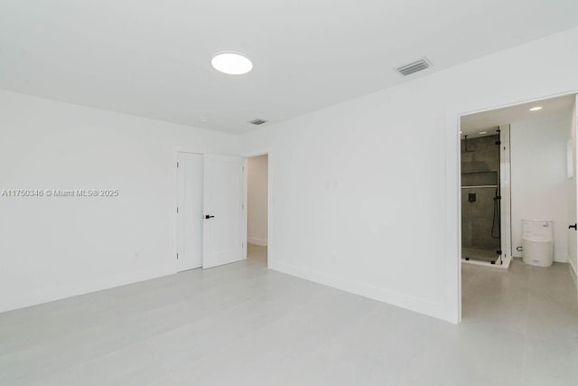 unfurnished room with visible vents and baseboards
