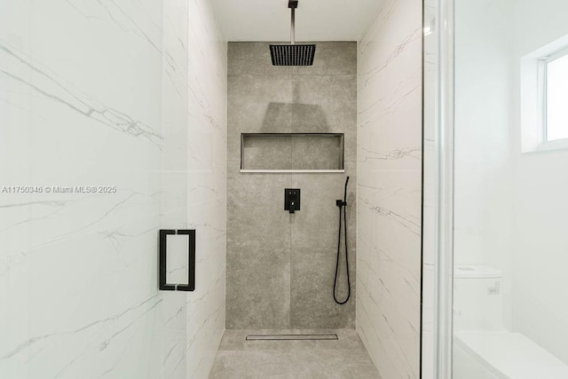 bathroom with a marble finish shower