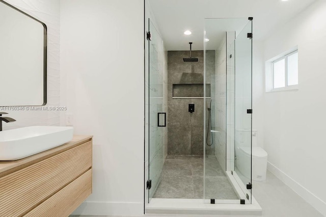 full bathroom with recessed lighting, baseboards, a shower stall, and vanity