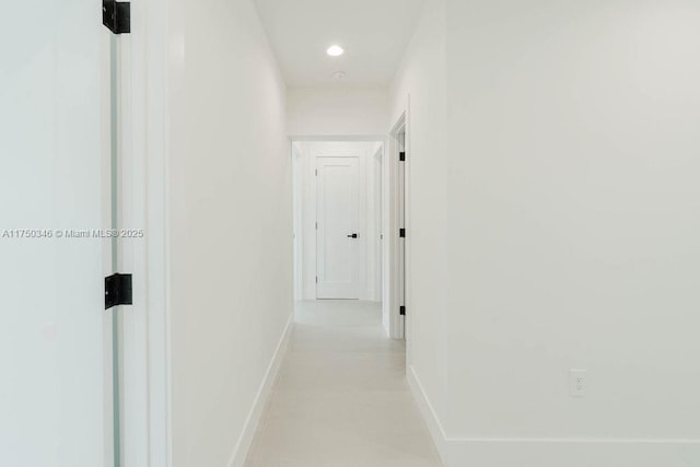 hallway with baseboards and recessed lighting