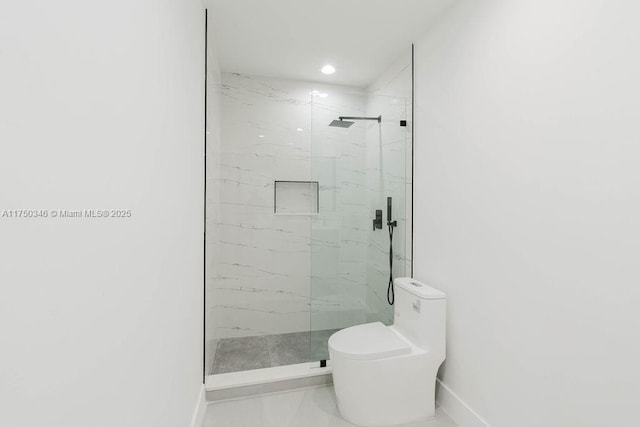 bathroom with marble finish floor, a marble finish shower, toilet, and baseboards