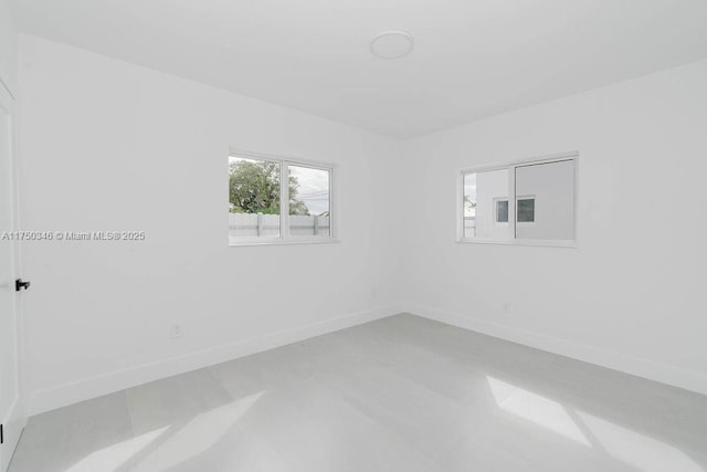 spare room with baseboards