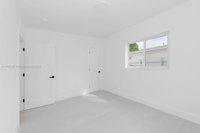 empty room featuring baseboards