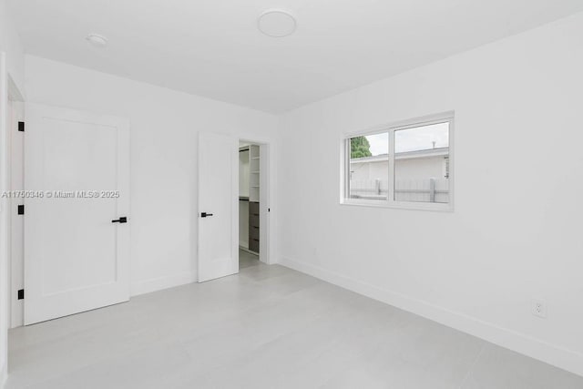 unfurnished room featuring baseboards