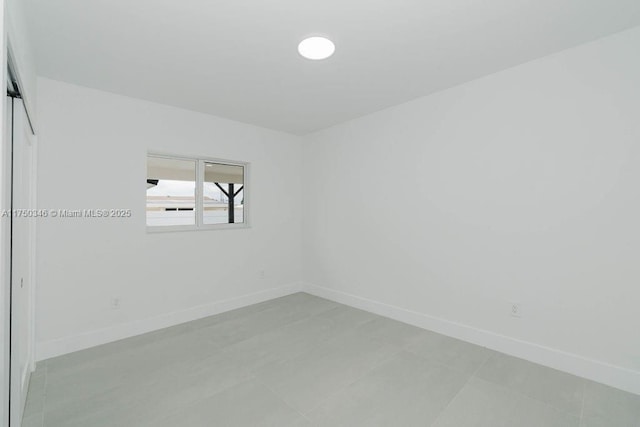 spare room featuring baseboards