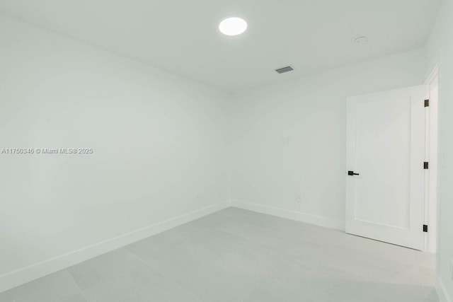 unfurnished room with visible vents and baseboards