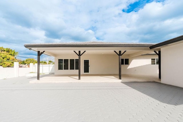 back of property with a patio area, fence, and stucco siding