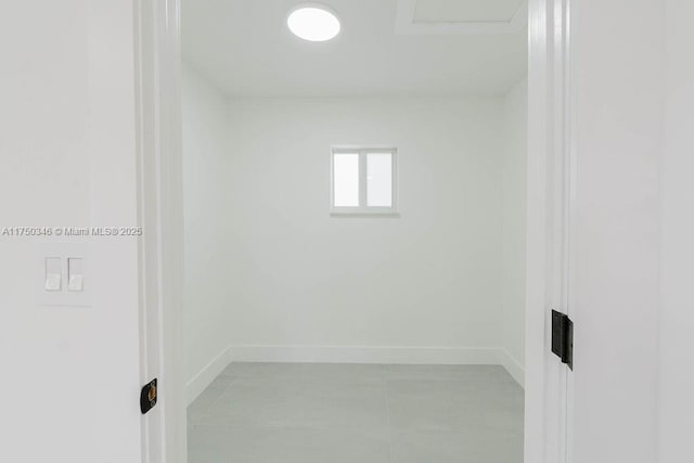 unfurnished room featuring baseboards