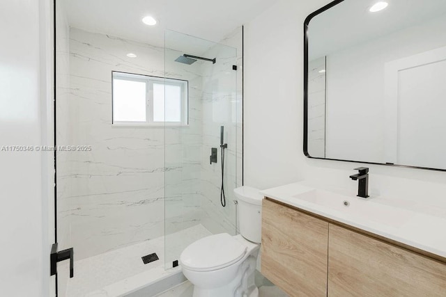 full bathroom featuring toilet, a marble finish shower, vanity, and recessed lighting
