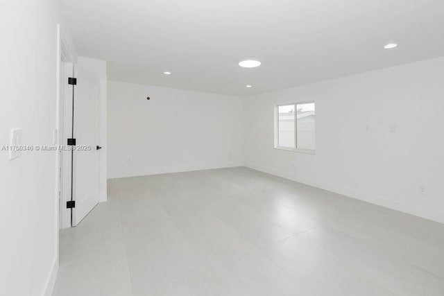 spare room featuring baseboards and recessed lighting