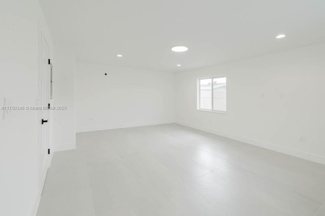 unfurnished room with baseboards and recessed lighting
