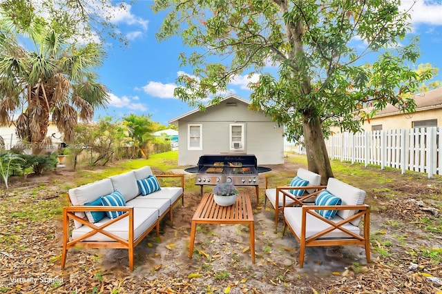 view of patio / terrace featuring grilling area, an outdoor living space, and a fenced backyard