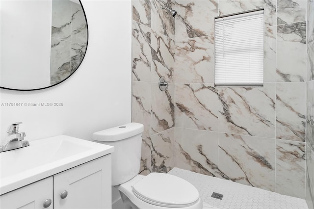 bathroom with toilet, a shower stall, and vanity
