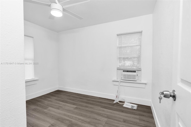 empty room featuring dark wood-style floors, cooling unit, baseboards, and a ceiling fan