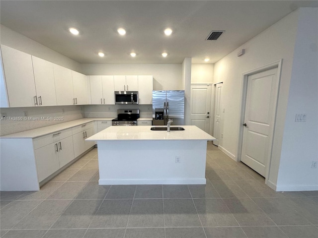 kitchen with visible vents, a kitchen island with sink, recessed lighting, stainless steel appliances, and white cabinets