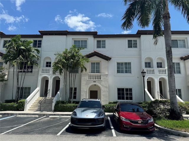 view of building exterior with uncovered parking