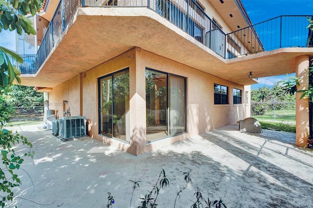 view of patio / terrace featuring cooling unit and a balcony