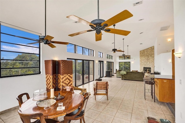 sunroom featuring plenty of natural light, a fireplace, and visible vents